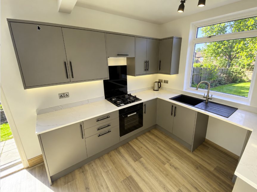 Taupe kitchen with black bar handles, marble-effect worktops and lighting under the wall units